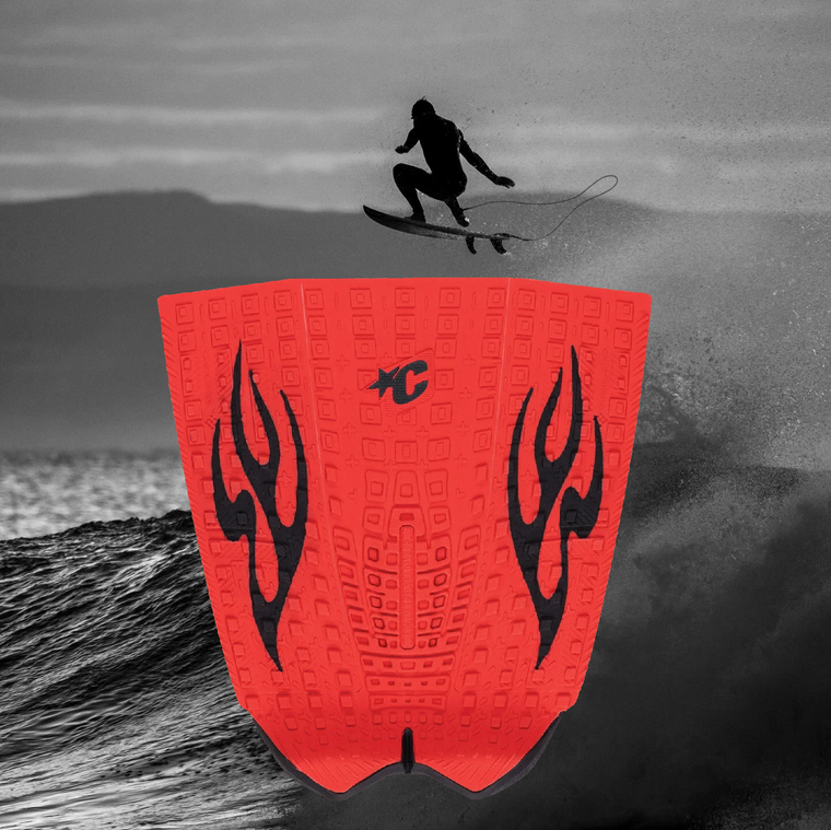 Red Creatures of Leisure Griffin Colapinto tailpad with black flame design, surfer jumping a wave in background at Melbourne Surfboard Shop