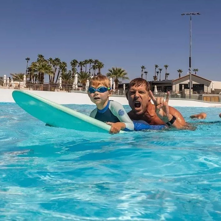 Father and son surfing on a softboard in a pool, Melbourne Surfboard Shop