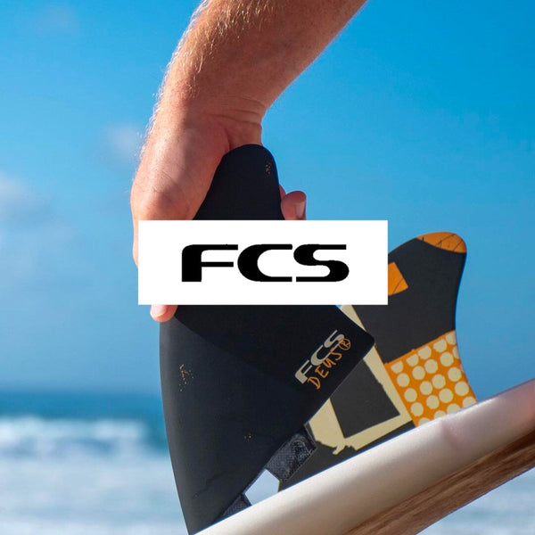 FCS Surfboard Tri Set Fins being inserted into a surfboard at Melbourne Surfboard Shop which has FCS Fins, Board bags, wetsuits.