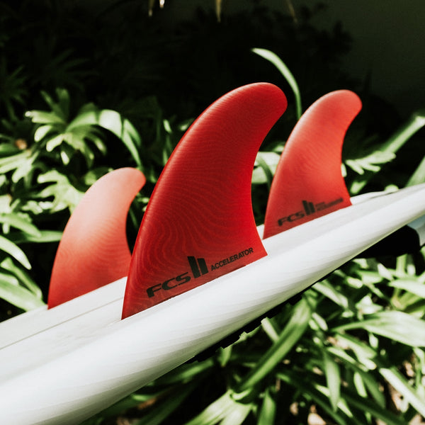 FCS II - Neo Glass Eco Range - Tri Fin Performer on the back of a surfboard