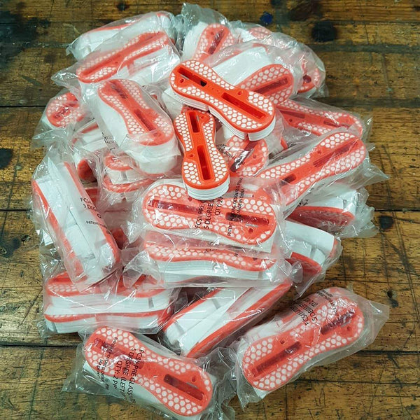 Red and White FCS Surfboard Plug Systems