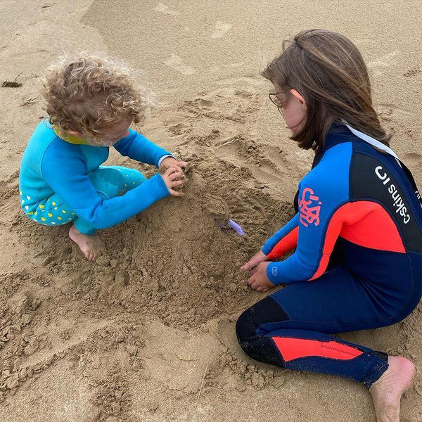 At the beach in a C Skins full length kids wetsuit.