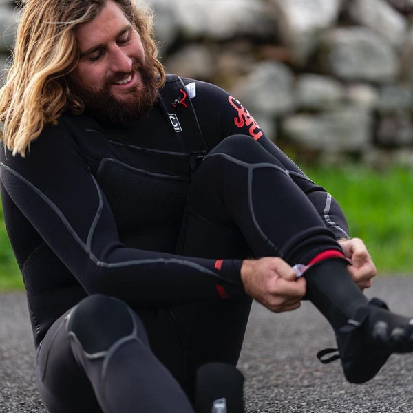 Putting on all the C Skins wetsuit accessories before surfing.