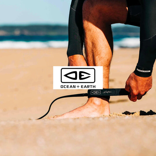 Ocean & Earth - Legrope getting placed on ankle before surfing.