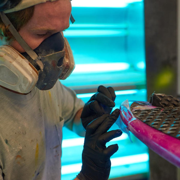 Adding resin to a surfboard repair - Melbourne Surfboard Shop