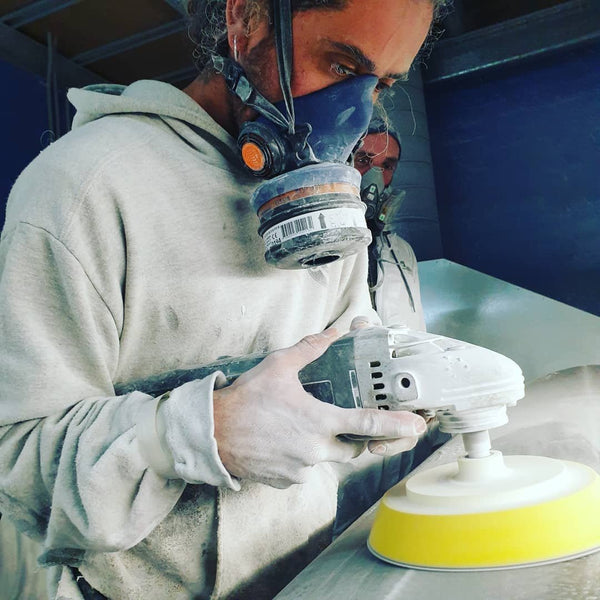 Melbourne Surfboard SHop - Sanding Pads buffing a surfboard with the pad attachment on a grinder.