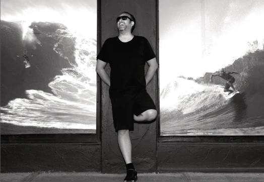 Zak Koniaras standing out front of his surfboard shop in Thornbury